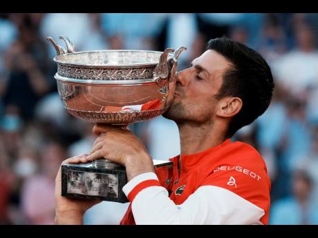Serbia’s Novak Djokovic kisses the cup after defeating Stefanos Tsitsipas of Greece in their final match of the French Open tennis tournament at the Roland Garros Stadium in Paris, France, yesterday.