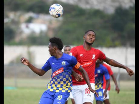 Molynes United’s Nicholas Nelson (left) goes up for a header with UWI FC’s Sheldon McKoy during their Jamaica Premier League encounter at the UWI Mona Bowl on Sunday, January 26, 2020.