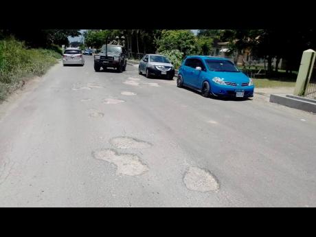 Potholes litter the newly resurfaced roadway, much to the annoyance of motorists and residents of Chantilly.