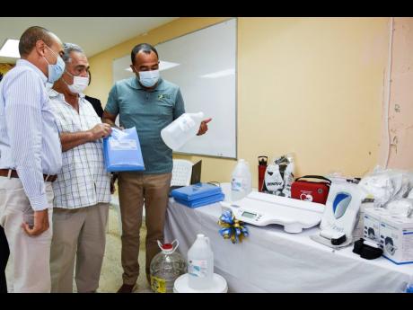 Credit: Nicholas Nunes From left: Wayne Chen, chairman, Southern Regional Health Authority; William Shagoury, custos of Clarendon; and Christopher Tufton, minister of health & wellness, at the handover of medical equipment at the May Pen Hospital.