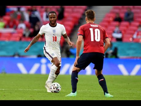 England’s Raheem Sterling runs with the ball at Czech Republic’s Patrik Schick (right) during the Euro 2020 championship group D match between the Czech Republic and England at Wembley stadium in London, yesterday. England won 1-0.