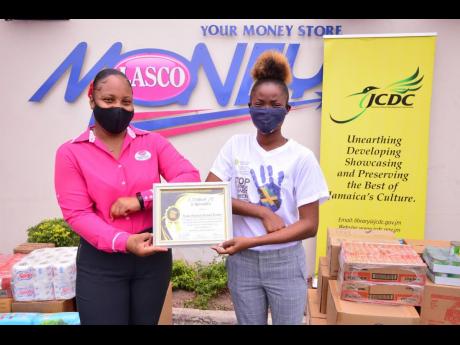 Lishaun Roberts, public relations officer of the Linstead Community Development Committee youth arm (right), proudly shares a photo with Nikeisha Alexander, sponsorship and promotions coordinator at LASCO Financials Services, after presenting to her a cert