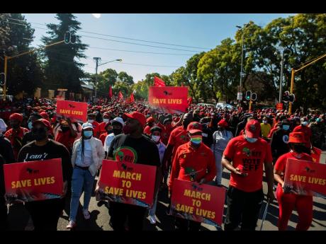 Members of the Economic Freedom Fighters stage a protest march in Pretoria, South Africa yesterday, demanding that vaccines from China and Russia be included in the country’s vaccine rollout programme. South Africa’s third wave of COVID-19 infections i
