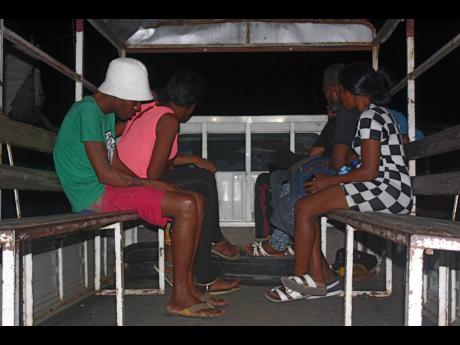 
In this 2016 file photo, alleged prostitutes are seen in a police truck after they were detained in an early morning operation in the Montego Bay. 