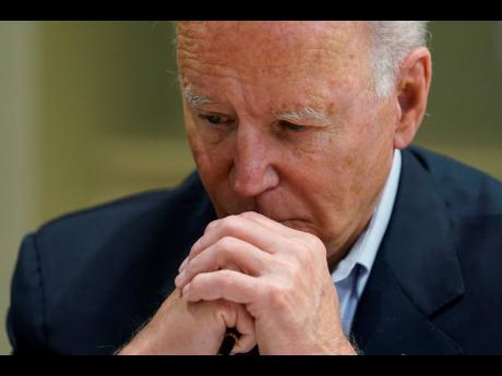 President Joe Biden listens during a briefing with first responders and local officials in Miami Beach yesterday, on the condo tower that collapsed in Surfside, Florida, last week.