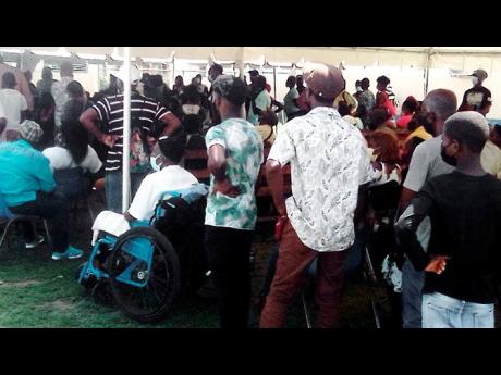 Credit: Photo by Ruddy Mathison Dozens of outpatients wait for medical attention at Spanish Town Hospital. None of the 157 junior doctors turned up for work Thursday.