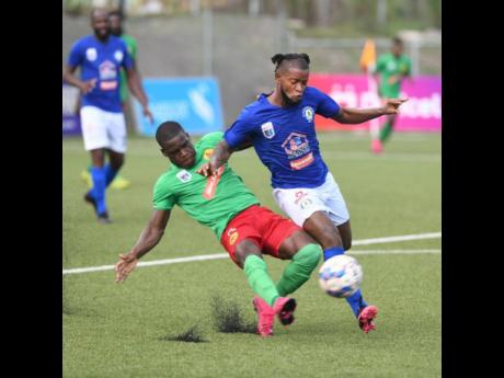 Credit: Gladstone Taylor Humble Lion's Lorenzo Lewin (left) slides in to tackle Mount Pleasant's Kemar Beckford during the Humble Lion vs Mount Pleasant Jamaica Premier League clash at the UWI/JFF/Captain Horace Burrell Centre of Excellence on Saturday, July 3, 2021.