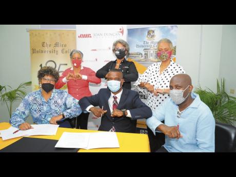 
Seated from left: Patricia Sutherland, chairman, JMMB Joan Duncan Foundation; Asburn Pinnock, president, Mico University College; Franklyn Bennett, director, School of Continuing Studies, (standing from left) Catherine Smith, CFG project manager at the Fo