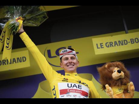 Credit: AP
Slovenia’s Tadej Pogacar, wearing the overall leader’s yellow jersey, celebrates on the podium after the eighth stage of the Tour de France cycling race, over 150.8 kilometres with start in Oyonnax and finish in Le Grand-Bornand, France, yesterday.