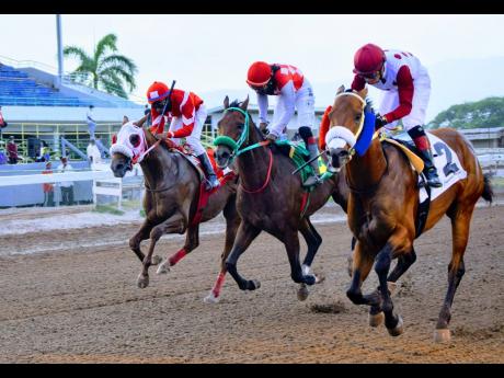
EAGLE ONE (right) ridden by Dick Cardenas wins the Labour Day trophy ahead of ANOTHER BULLET (Robert Halledeen) and the late rushing EXCESSIVE FORCE (Oshane Nugent) over 7 furlongs on the eight-race card at Caymanas Park on Tuesday, May 25, 2021.