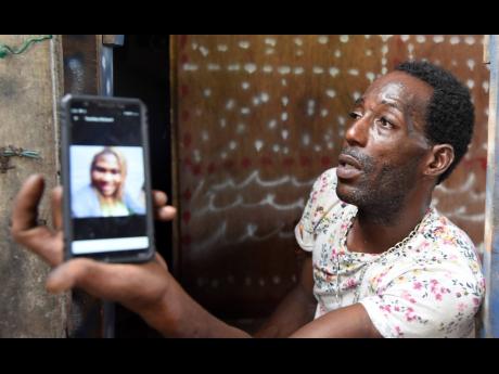 Aaron Morgan mourns the police shooting death of his babymother, Tashika McLeod, in Kingston on Monday. 