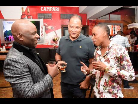 Credit: Nicholas Nunes/Photographer From left: Everton Bryan, chairman, International Asset Services, Damian Suepat and life skills coach Dane Lynch.