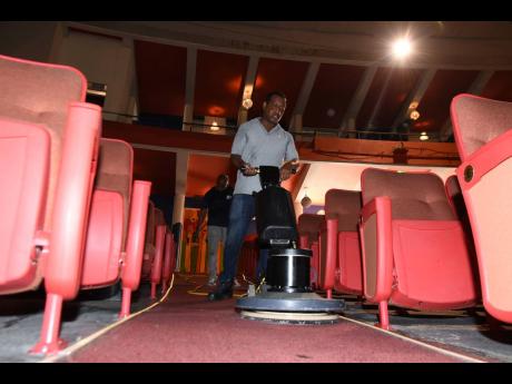 Credit: Kenyon Hemans/Photographer Michael Ebanks from Manpower and Maintenance Services Limited cleans the carpets of the Little Theatre.
