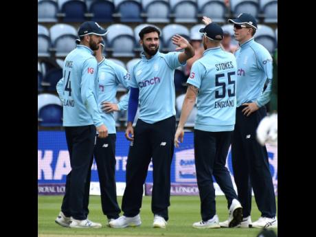 England’s Saqib Mahmood (centre) celebrates with teammates after dismissing Pakistan’s Faheem Ashraf during the first One-Day International cricket match against Pakistan at Sophia Gardens in Cardiff, Wales, yesterday.