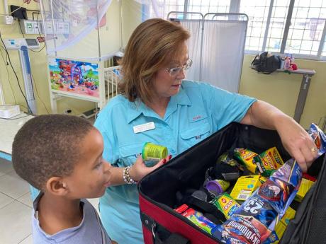 New school supplies make for very happy patients in the hospital and for students in school. Through the Issa Trust Foundation and Couples Resorts, Diane Pollard (right) says persons can pack to make a difference and improve the lives and education for Jam