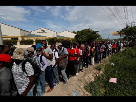 People waiting for days to apply for visas are seen outside the US Embassy, where they were told the embassy continues to be closed in Port-au-Prince, Haiti, on Monday, July 12, in the wake of the assassination of President Jovenel Moïse on July 7.