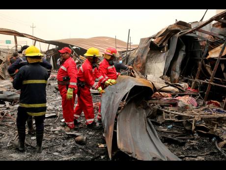 Rescuers look for bodies after a catastrophic blaze erupted on Monday at a coronavirus hospital ward in the al-Hussein Teaching Hospital in Nasiriyah, Iraq.