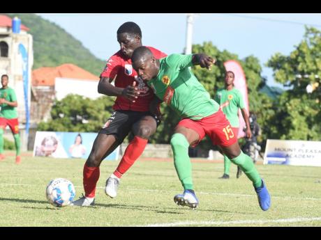 Marlon Martin (left) of Arnett Gardens and Humble Lion’s Lorenzo Lewin battling for possession during their Jamaica Premier League match on Monday at the Stadium East field. Arnett Gardens won 2-1.