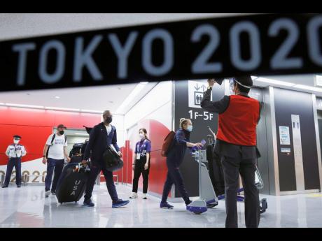 Olympic athletes from the United States arrive at Narita International Airport in Narita, east of Tokyo, on July 1, 2021. 