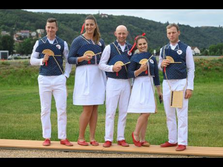 From left:  Czech track cyclist Tomas Babek, hammer thrower Katerina Safrankova, rider Miroslav Trunda, artistic gymnast Aneta Holasova and rider Miloslav Prihoda pose wearing the new Olympic uniforms for the Tokyo Olympic Summer Games 2020.