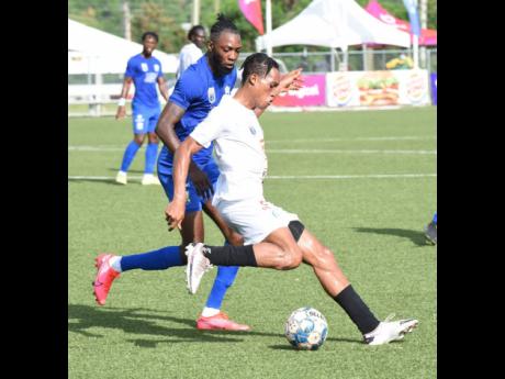 Credit: Ian Allen/Photographer Mount Pleasant’s Alwayne Harvey (front) comes under pressure from Molynes United’s Jermy Nelson during their Jamaica Premier League game at the UWI/JFF Captain Horace Burrell Centre of Excellence on Sunday.