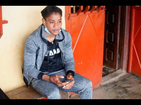 Fatoumata Yarie Camara, a Guinean freestyle wrestler scheduled to compete in the Tokyo Olympics, sits at her home in Conakry, Guinea, on Wednesday.