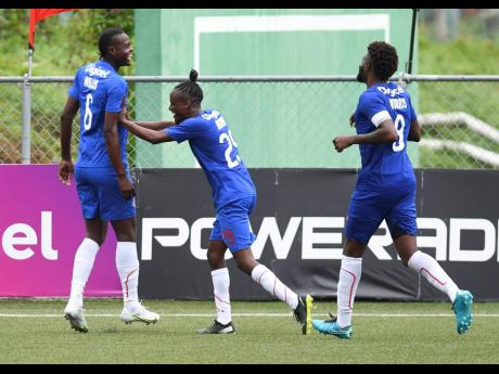 Credit: Ricardo Makyn Portmore United’s Chavany Willis (centre) celebrates his goal with teammates Taja Brown (left) and Ricardo Morris during their 3-0 win over Humble Lion in the Jamaica Premier League at the UWI/JFF Captain Horace Burrell Centre of Excellence yesterday.