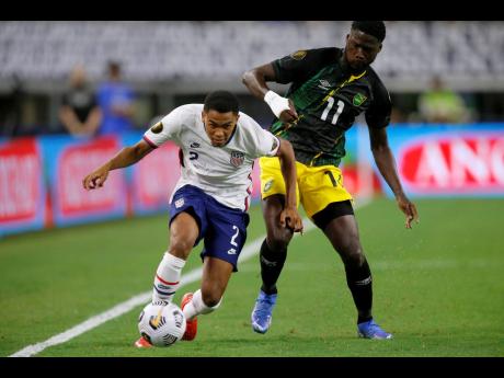 United States defender Reggie Cannon gets past Jamaica forward Shamar Nicholson (right) during their Gold Cup quarterfinals match in Arlington, Texas, on Sunday.
