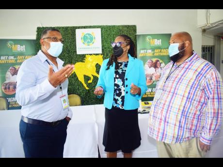 Denzil Miller (left), Racing Secretary, Supreme Ventures Racing and Entertainment Limited (SVREL), talks with Solomon Sharpe (right), Executive Chairman, SVREL and Lorna Gooden,  General Manager, SVREL), during the press conference to announce details of t