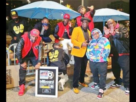 Credit: Contributed The Wu-Fam in celebration mode with their Billboard plaques.
