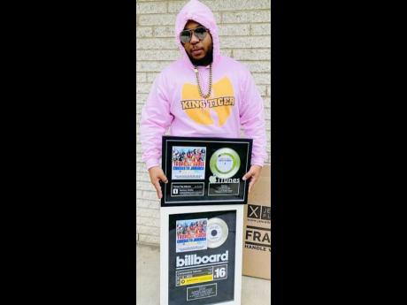 Credit: Contributed King Tiger shows off his Billboard plaques.
