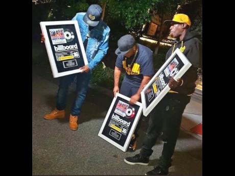 Credit: Contributed
Members of the Wu-Tang Clan show off the plaques they received for ‘Tropical House Cruises to Jamaica: The Reggae Collector’s Edition’, which hit number 16 on the Billboard Compilation Album chart.
