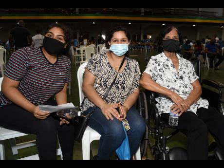 Three generations of Kirpalani family members turn up at the National Arena to be vaccinated against COVID-19 during the Vaccination Blitz on Saturday. They are (from left) Siya Kirpalani, 18 years old; her mother, Divya Kirpalani; and her grandmother, Jyo