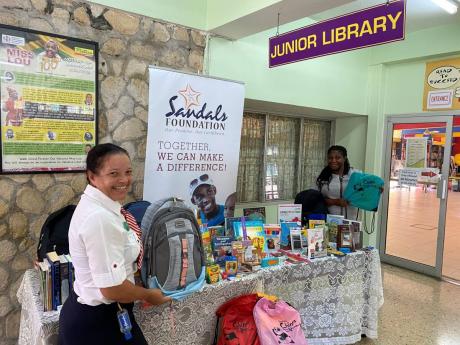 Regional Public Relations Manager at Sandals Grande Ocho Rios, Lyndsay Isaacs, spearheaded the donation of school supplies to the St Ann Parish Library on behalf of the Sandals Foundation. Isaacs (left) is pictured with senior librarian Opal Scott. The don