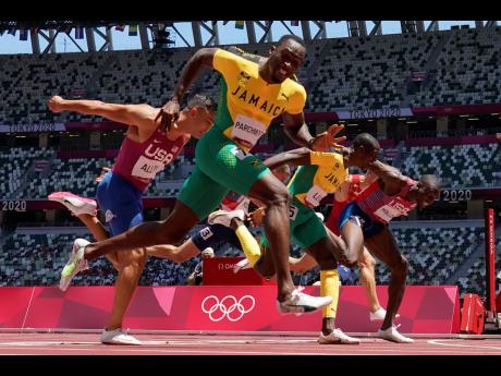 Hansle Parchment (left), of Jamaica, wins the men’s 110m hurdles final ahead of Grant Holloway (right), of the United States, and Jamaica’s Ronald Levy (centre) at the 2020 Summer Olympics, in Tokyo, Japan on Thursday.
