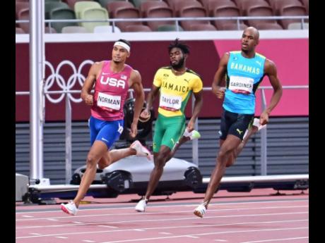 Jamaica’s Christopher Taylor (centre) runs between The Bahamas’ Steven Gardiner (right) and the United States’ Michael Norman during the men’s 400 metres final at the Tokyo 2020 Olympic Games, at the Tokyo Olympic Stadium in Tokyo, Japan, on Thursd