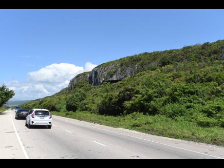 Motorists traversing Queens Highway in St Ann.