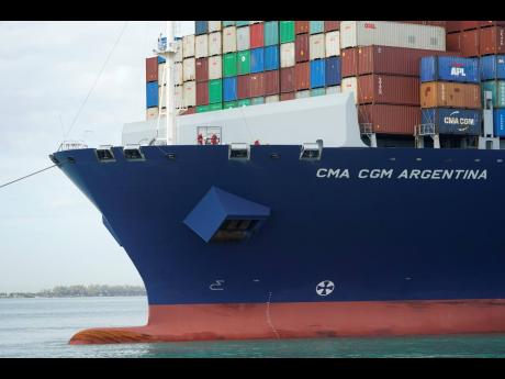 In this April 6, 2021 photo, crew members stand on the bow as the CMA CGM Argentina arrives at PortMiami, the largest container ship to call at a Florida port in Miami.