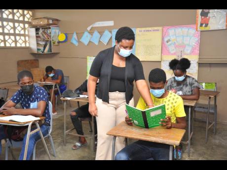
Shinnell Williams, teaching mathematics to students at Brandon Hill Primary. 