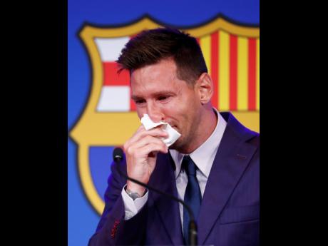 Lionel Messi cries at the start of a press conference at the Camp Nou stadium in Barcelona, Spain, yesterday.