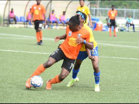Tivoli Gardens’ Kemar Flemmings (front) turns away from Harbour View’s Odorland Harding during their Jamaica Premier League game at the UWI/JFF Captain Horace Burrell Centre of Excellence in St Andrew on Saturday.