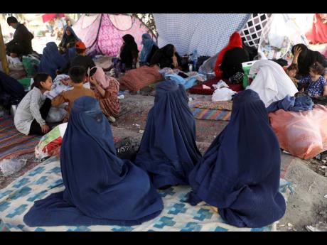 Internally displaced Afghans from northern provinces, who fled their home due to fighting between the Taliban and Afghan security personnel, take refuge in a public park Kabul, Afghanistan, yesterday.