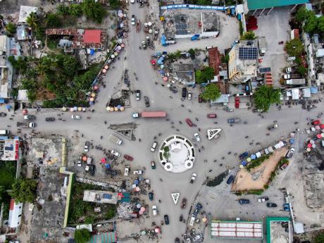 Vehicles drive through a roundabout in Les Cayes, Haiti, on Wednesday, five days after the city was struck by a 7.2-magnitude earthquake.