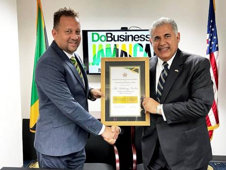  Oliver Mair (left), consul general of Jamaica in Miami, shares a happy moment with the newly appointed honorary investment adviser of Jamaica to Florida, Anthony Barbar.  Barbar will be working to promote Jamaican investment opportunities in Florida,
