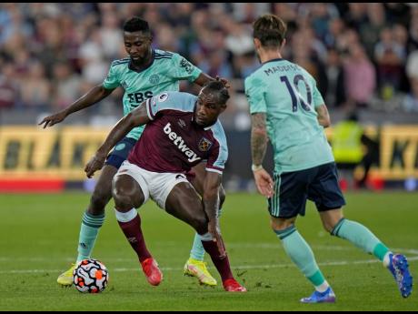 Credit: AP West Ham’s Michail Antonio (centre) holds off Leicester’s Wilfred Ndidi (left) and James Maddison during the English Premier League soccer match between West Ham United and Leicester City and at the London Stadium in London on Monday.