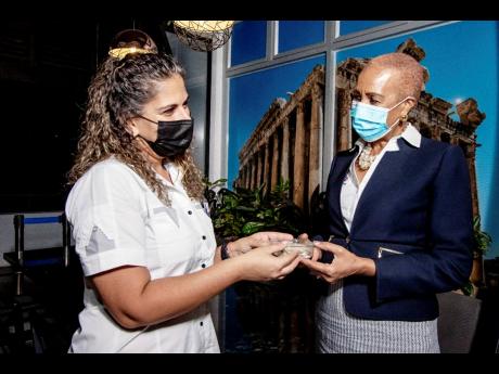 Co-principal of Chez Maria Nancy Hado gives Fayval Williams a traditional Lebanese dessert known as a date maamoul, made by matriarch Maria herself.