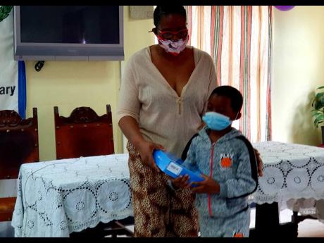 Ricardo Warlock of Salt Spring receives a tablet from Sarah’s Children’s Sonia Clarke Bowen for his ‘Act of Kindness’. 
