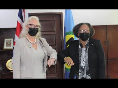 Credit: Contributed Jane Miller (left), ambassador of the United Kingdom to CARICOM, greets CARICOM Secretary General Dr Carla Barnett after she presented her credentials recently.