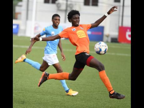 Waterhouse’s Shaquille Bradford (left) moves in to tackle Rushane Thompson of Tivoli Gardens during a Jamaica Premier League match on July 27 at the UWI-JFF Captain Horace Burrell Centre of Excellence.