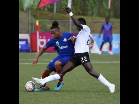 Credit: Ian Allen Ian Allen
Damono Solomon (left) of Portmore United is strongly tackled by Cavalier's Colin Anderson during their Jamaica Premier League match at the UWI-JFF Captain Horace Burrell Centre of Excellence on Friday.